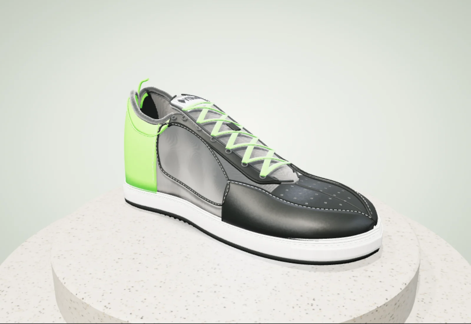 Sneaker in zwart, grijs en VTStudio-groen op een terrazzo-sokkel